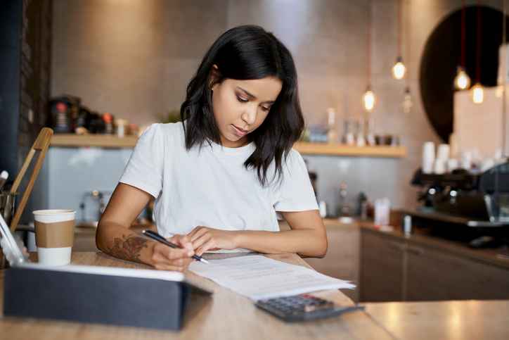 Woman reviewing paperwork on desk